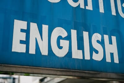 The word English. White lettering on a blue sign